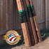 Wooden planks leaning against a wooden fence with 'Made in the USA' and warranty badge.