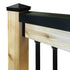 A close-up image of a handrail cover installed on a wooden handrail, showing the product in black color.