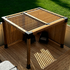 Wood louver top kit in a beautiful backyard on a deck with a lush lawn in the background